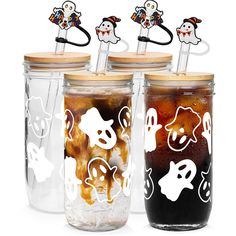 three halloween themed mason jars with lids and straws in them, one is filled with liquid and the other has stickers on top