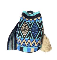 Handmade, exotic and stylish! The stunning, one-of-a-kind Wayuu bag is 100% handmade and carefully crocheted by Wayuu artisans in the desert area of La Guajira in northern Colombia. This unique bag from our Limited Edition is tightly woven by hand using the most traditional single thread technique, making the bag the highest quality, keeping its shape perfectly and being our most sophisticated piece of the entire collection, taking approximately 25 days to weave. This is a very rare item. The be Blue Rectangular Bucket Bag For Vacation, Blue Rectangular Bucket Bag For Travel, Blue Handwoven Bag As A Gift, Blue Shoulder Bucket Bag For Vacation, Artistic Blue Shoulder Bag For Everyday Use, Blue Shoulder Bag With Removable Pouch For Vacation, Blue Bags With Removable Pouch For Vacation, Blue Handmade Bags As Gifts, Blue Handheld Bags For Vacation