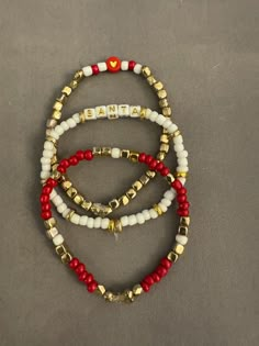 Gorgeous 3 piece beaded bracelets for the perfect addition to your Christmas style! Deep red, metallic gold, and white colors go beautifully together! "SANTA" is on his way! Red And White Beaded Bracelet, Holiday Beaded Bracelets, Christmas Bead Bracelets, Christmas Bracelets Beaded, Christmas Bracelet Ideas, Winter Bracelets