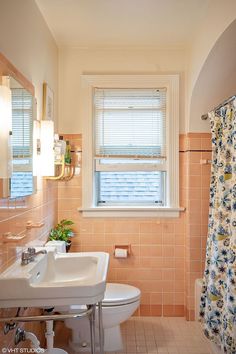 a bathroom with a sink, toilet and bathtub next to a window in it