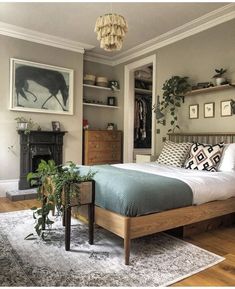 a bedroom with a bed, dresser and plants