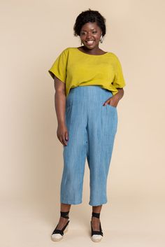 a woman in yellow shirt and blue pants