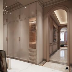 the interior of an elegant home with marble floors and white walls, along with large closets