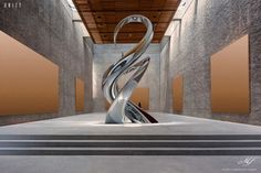 an artistic sculpture in the middle of a room with concrete walls and flooring on either side