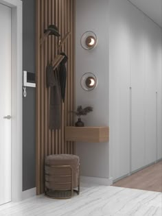 a white and brown room with some lights on the wall next to a stool, coat rack and mirror