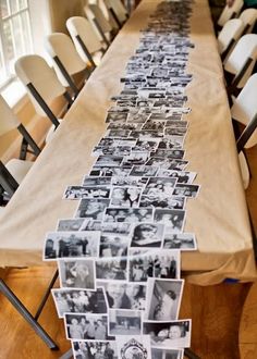 a long table topped with pictures and chairs