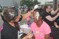 two women with face paint having their faces painted