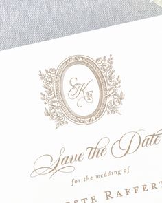 an elegant save the date card is displayed on top of a white envelope with gold lettering