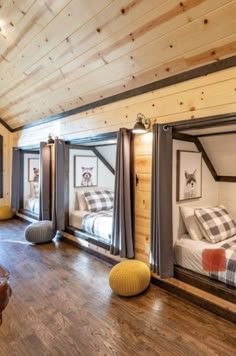 a bedroom with bunk beds and windows in the ceiling is made out of wood planks