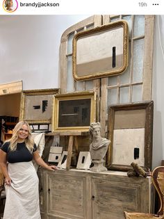 a woman standing in front of some old furniture