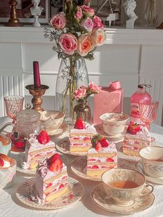 a table topped with plates and cups filled with cake