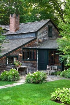 a small wooden house surrounded by lush green trees