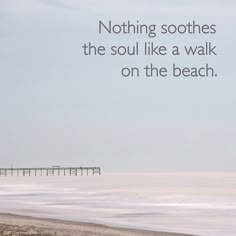 a person walking on the beach with a quote about nothing soothes the soul like a walk on the beach