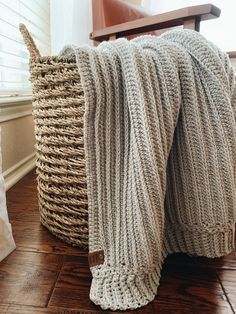 two baskets sitting next to each other on the floor