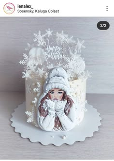 a cake with a woman's face on it and snowflakes around the edges