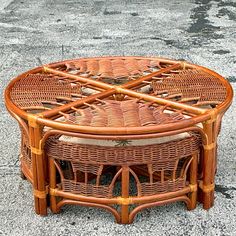 a wicker coffee table sitting on the ground