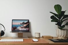 a computer monitor sitting on top of a wooden desk next to a keyboard and mouse