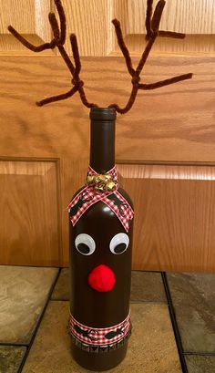 a wine bottle decorated to look like a reindeer