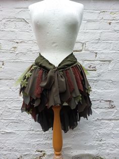 Upcycled Bustle Woman's Clothing   Mix of earthy colours: shades of greens and browns. A lot of chiffone, lace and floral embroidered pieces. Adjustable waist with a cotton stripe. Messy and romantic:)             Size Small/Medium 29.5inch(75cm) accross + cotton stripes to tie nice bow Length max 23(58cm) Are you looking for a different size or colours?                                                                                   I will be more than happy to design something just for you. :) Forest Pixie, Leaf Skirt Fairy, Dryad Costume, Fairy Gown, Forest Fashion, Leaf Skirt, Pixie Skirt, Fairy Skirt, Fairy Clothes