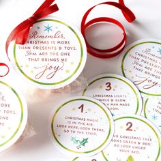 six christmas tags with red ribbon on them and some other items around the tag that says,