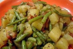 the amazing crockpot ham, green beans and potatoes recipe is shown on an orange plate