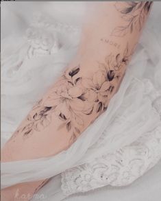 a woman's leg with flowers on it