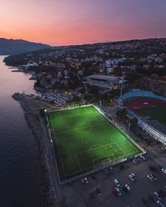 an aerial view of a soccer field at sunset