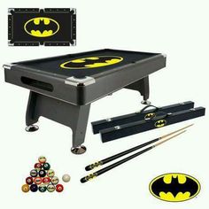 the batman pool table with cues and ball set is shown in front of an assortment of accessories