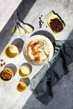 a table topped with bowls and plates filled with food