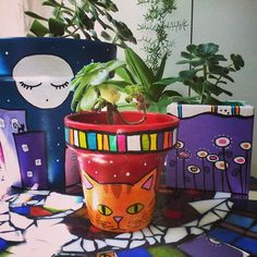 a potted plant sitting on top of a table next to other pots and boxes