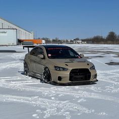 a car parked in the snow near a building