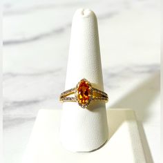 0.79ct Marquise Madeira Citrine With 0.29ctw Round Zircon 18k Yellow Gold Over Sterling Silver Ring. Measures Approximately 0.78"L X 0.52"W. Primary Stone Gemstone Color: Orange Gemstone Classification: Natural Gemstone Ctw: 0.79 Gemstone Dimensions: 10.00mm L X 5.00mm W Gemstone Enhancement: Heated Gemstone Full Name: Madeira Citrine Material Composition: Natural Origin Country: Brazil Gemstone Shape: Marquise Accent Stone(S) Gemstone Color: White Gemstone Classification: Natural Gemstone Ctw: Ss Ring, Cubic Zirconia Wedding Rings, Infinity Diamond Ring, Marquise Ring, Fancy Rings, Vintage Sterling Silver Rings, Vintage Diamond Rings, Size 10 Rings, Orange Gold