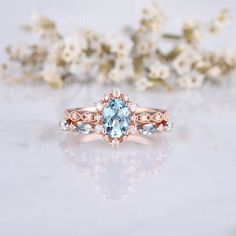 a ring with an oval blue topaz surrounded by white flowers