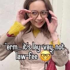 a woman wearing glasses holding her hand up to her face with the caption em it's lay - way, not law - fee