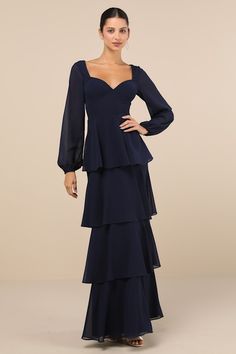 The Lulus Flawless Excellence Navy Blue Tiered Long Sleeve Maxi Dress was made to take everyone's breath away! This luxe dress has a lightweight woven chiffon composition that shapes princess-seamed cups, a V-neckline (and V-back), and slightly sheer, balloon-style long sleeves with elastic at the cuffs. The flattering, set-in waist tops a tiered, A-line skirt that falls to a sweeping maxi hem. A slender tying strap secures at the back, atop a hidden back zipper/clasp. Fit: This garment fits tru Fitted Tiered Chiffon Dress With Ruffles, Fitted Chiffon Dress With Tiered Ruffles, Fitted Chiffon Evening Dress With Sweetheart Neckline, Fitted Tiered Chiffon Dress, Chiffon Gala Dress With Lined Bodice, Gala Chiffon Dress With Lined Bodice, Fitted Chiffon Tiered Dress, Fitted Chiffon Dress With Lined Bodice, Formal Fitted Chiffon Dress With Sweetheart Neckline