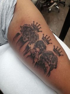 a man with a crown tattoo on his arm