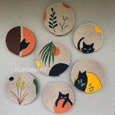 six woven coasters with cats and plants on them