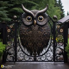 an owl statue sitting on top of a gate