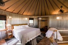 a bed sitting inside of a bedroom on top of a wooden floor