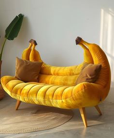 a banana shaped chair with two pillows on it