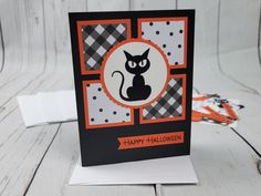 a black and white card with a cat on it's front, sitting on a table