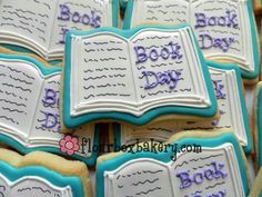 cookies decorated like books with the words book day written in blue and purple frosting