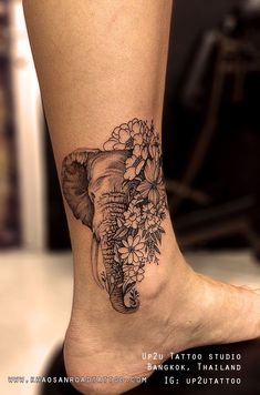 an elephant and flowers tattoo on the ankle by suzutato, via @ suzutatoo com