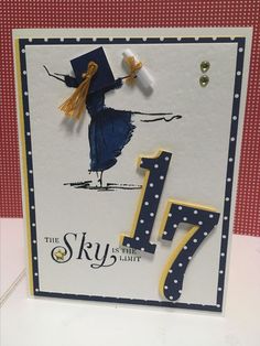 a card with the number 17 on it and a graduation cap in the shape of a girl