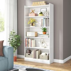 a living room with a blue couch and white bookcase