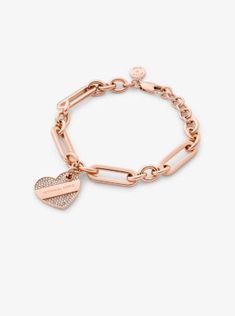 Give your jewelry collection a contemporary update with this chain-link bracelet. Crafted from rose-gold-plated brass, it features a heart-shaped pendant engraved with our logo lettering and dotted with sparkling pavé. Stack it with an array of other bracelets or wear it as a set with the matching necklace. Bracelet Rose Gold, Michael Kors Jewelry, Matching Necklaces, Heart Bracelet, Chain Link Bracelet, Link Bracelets, Rose Gold Plates, Precious Metals, Chain Link