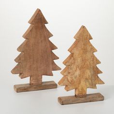 two wooden christmas trees are standing next to each other