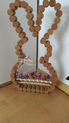 a cake made out of wine corks with flowers in the middle and hearts on top