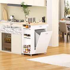 a kitchen with white cabinets and wooden floors