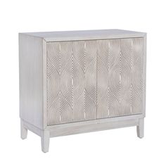 a white cabinet with an intricate design on the front and side panel, it is made from wood